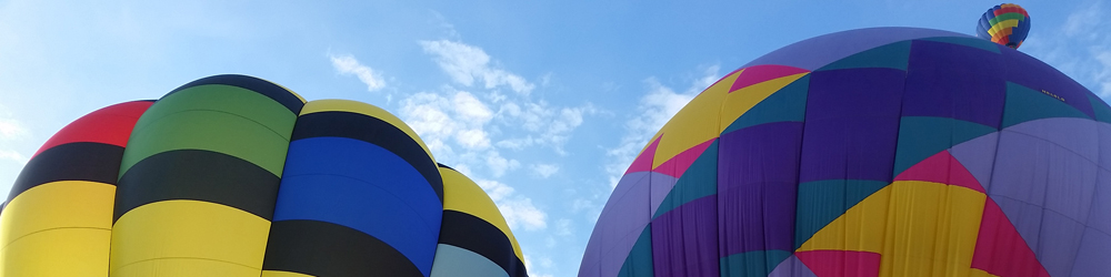 Photograph of three hot-air balloons during the annual Balloon Fiesta in Albuquerque.